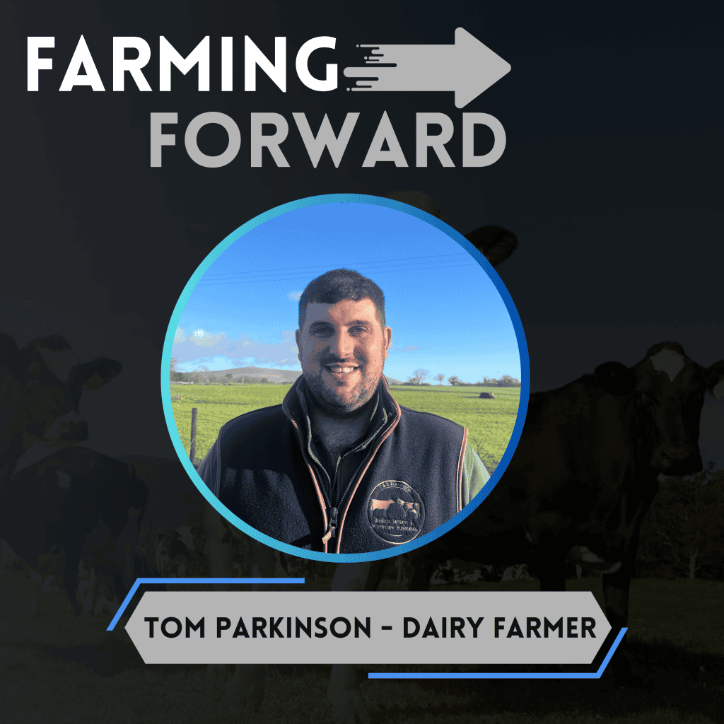 Dairy farmer Tom Parkinson speaking outdoors on farm with cows in background.